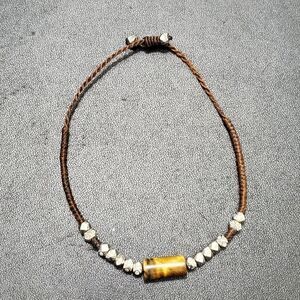 Adjustable corded bracelet with tigers eye stone